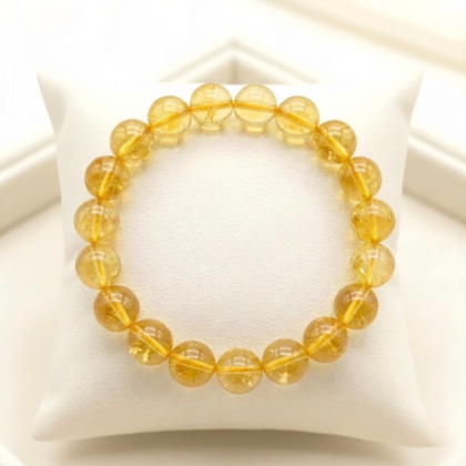Natural Citrine crystal bracelet featuring polished, transparent golden-yellow beads on a clear stretch cord from lakshya gems