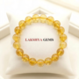 Natural Citrine crystal bracelet featuring polished, transparent golden-yellow beads on a clear stretch cord from lakshya gems
