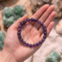 Natural Amethyst crystal bracelet featuring polished, deep purple translucent beads on a stretch cord from lakshya gems