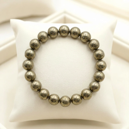 A premium natural pyrite crystal bead bracelet showing brilliant metallic gold colors and polished finish.