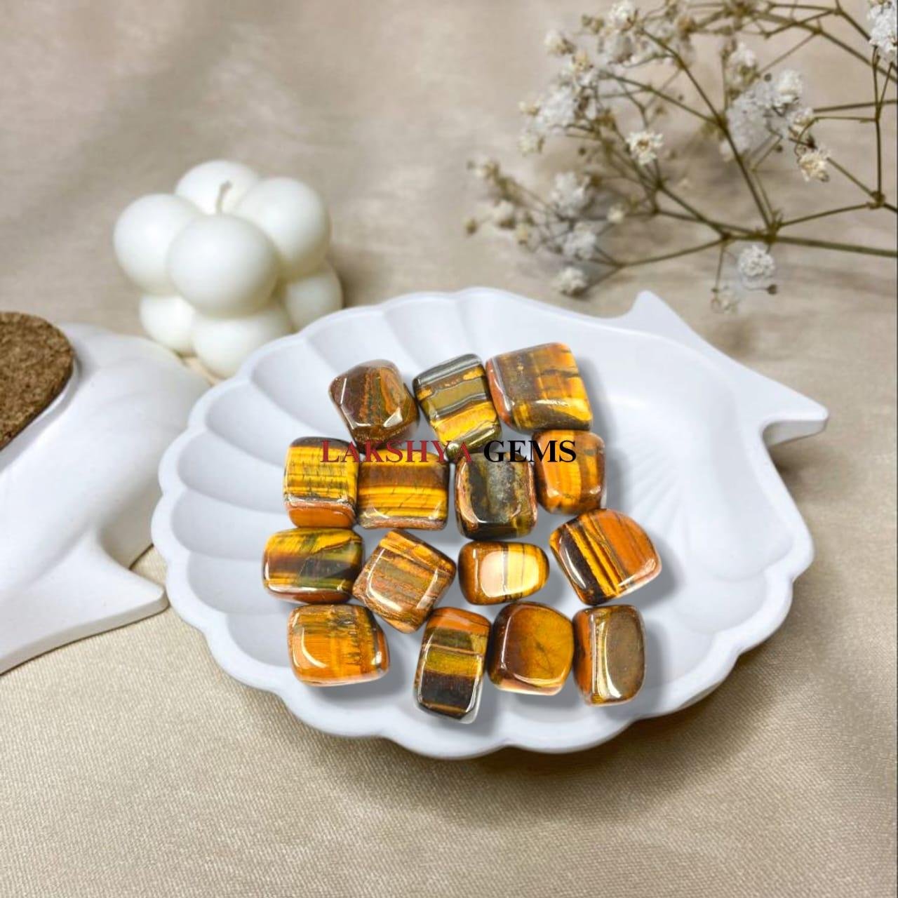 Polished Tiger Eye tumble stones showing golden-brown chatoyant bands for courage and focus.