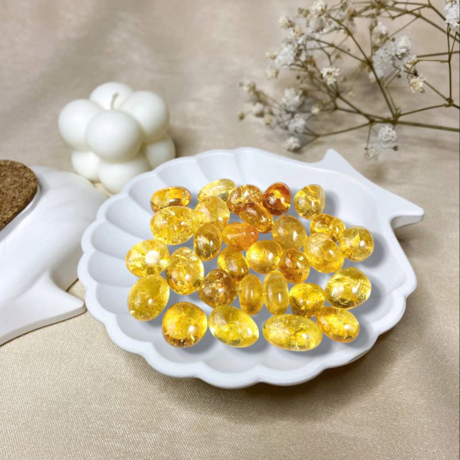 Polished natural Citrine tumble stones with a transparent golden yellow hue for wealth manifestation.