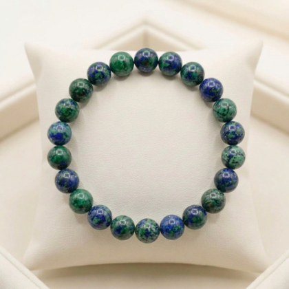 A premium Azurite crystal bracelet featuring deep, midnight-blue natural stones with a smooth polished finish. from lakshya gems mumbai