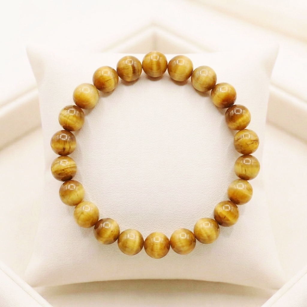 Natural Cat's Eye bracelet with a sharp chatoyant band of light across each polished gemstone.