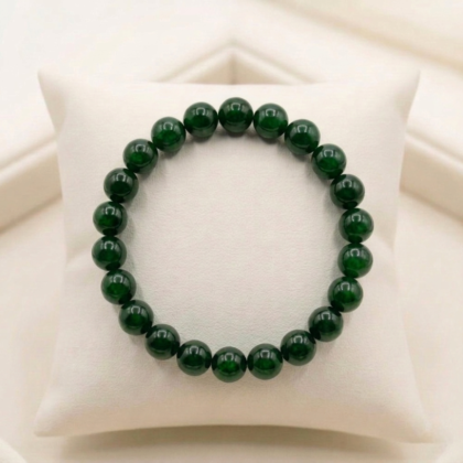 A premium Green Jade crystal bead bracelet showing various shades of natural forest green with a polished, waxy luster