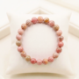 Natural Rhodochrosite crystal bracelet featuring polished raspberry-pink beads with white zig-zag bands from lakshya gems