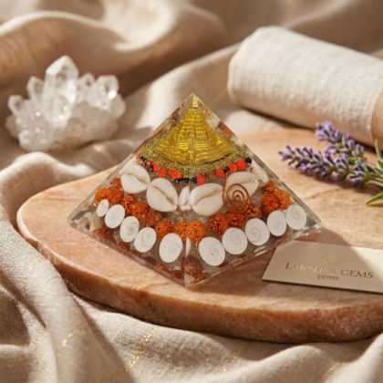 Dhan Lakshmi Pyramid with a clear resin finish showing Shree Yantra, Gomti Chakra, and Rudraksha beads inside from Lakshya Gems mumbai