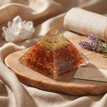A polished natural Carnelian pyramid showing vibrant orange-red hues from the Lakshya Gems collection.