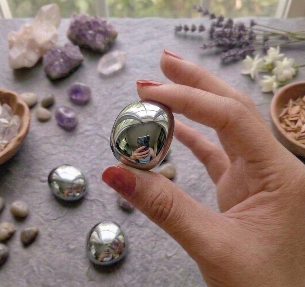 Authentic Elite Shungite crystal tumble showing a natural metallic silver luster and sharp glass-like fractures.