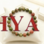 A high-quality Unakite crystal bead bracelet featuring a natural mottled pattern of olive green and peachy-pink colors.