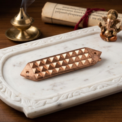 A pure copper Vastu pyramid strip showing multiple pyramid shapes for powerful energy correction and neutralizing defects.