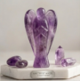 A hand-carved natural Amethyst crystal angel featuring deep purple hues and translucent polished finish.