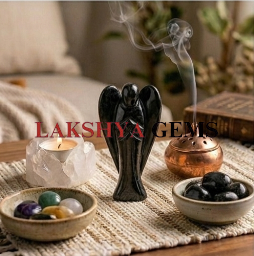 A hand-carved natural Black Tourmaline crystal angel with a deep jet-black color and smooth polished finish.