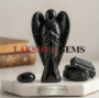A hand-carved natural Black Tourmaline crystal angel with a deep jet-black color and smooth polished finish.