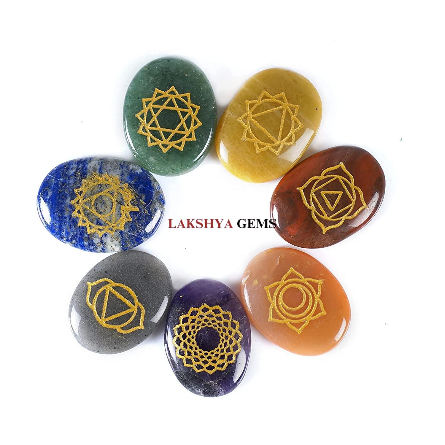Set of seven chakra gemstone coins plus a love coin, all featuring engraved sacred symbols