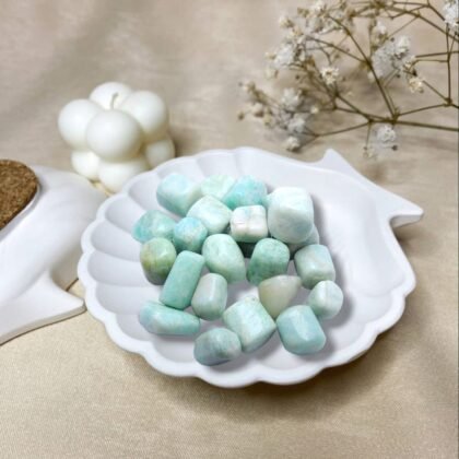 Polished Amazonite tumble stones in various shades of turquoise green for truth and calm.