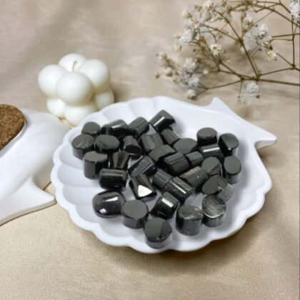 Set of polished Black Tourmaline tumble stones with a deep jet-black metallic luster.