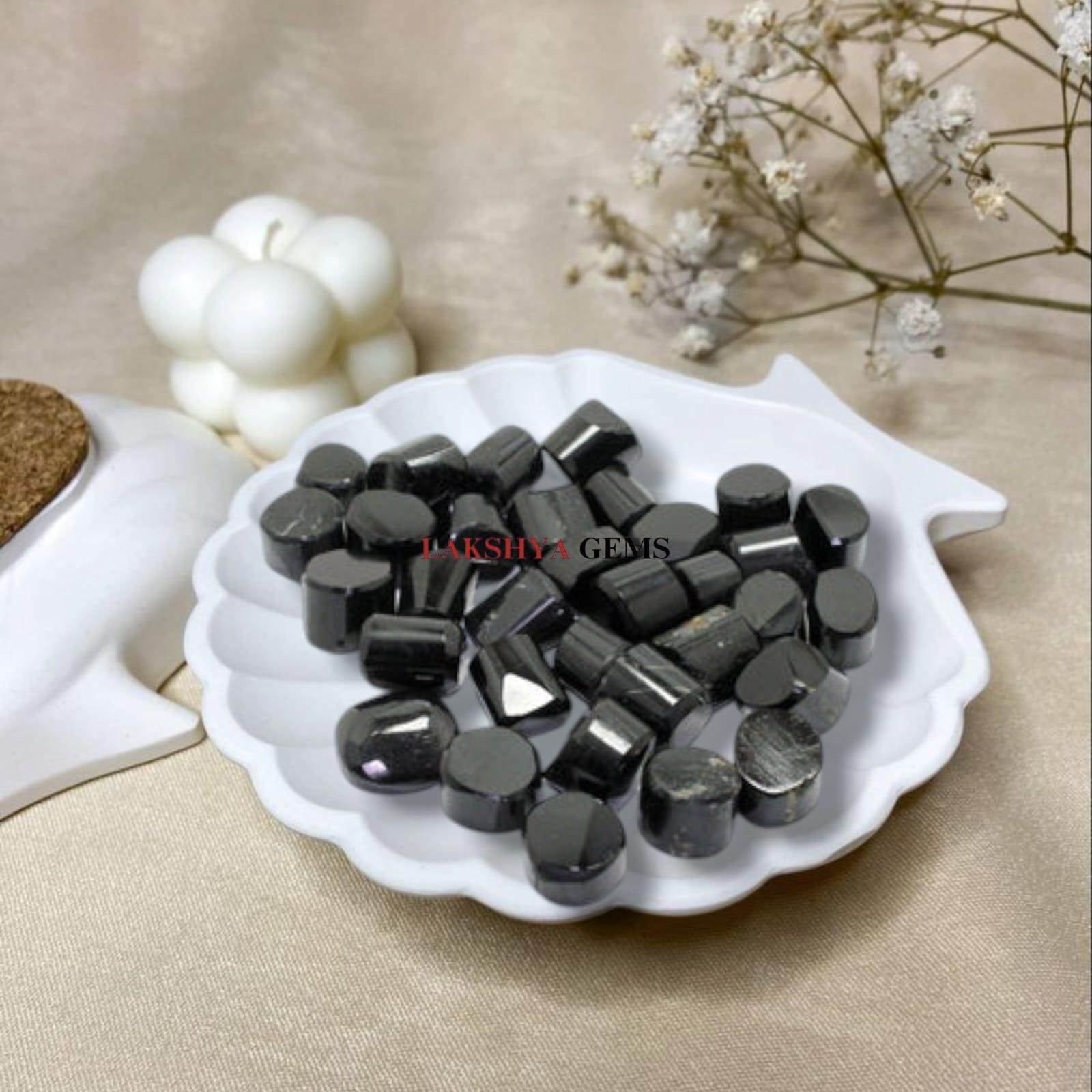 Set of polished Black Tourmaline tumble stones with a deep jet-black metallic luster.