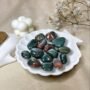 Polished Bloodstone crystal tumble stones featuring deep green colors with natural red jasper flecks.