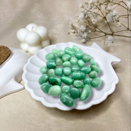Polished Green Aventurine tumble stones with a natural shimmering green color for luck from lakshya gems mumbai