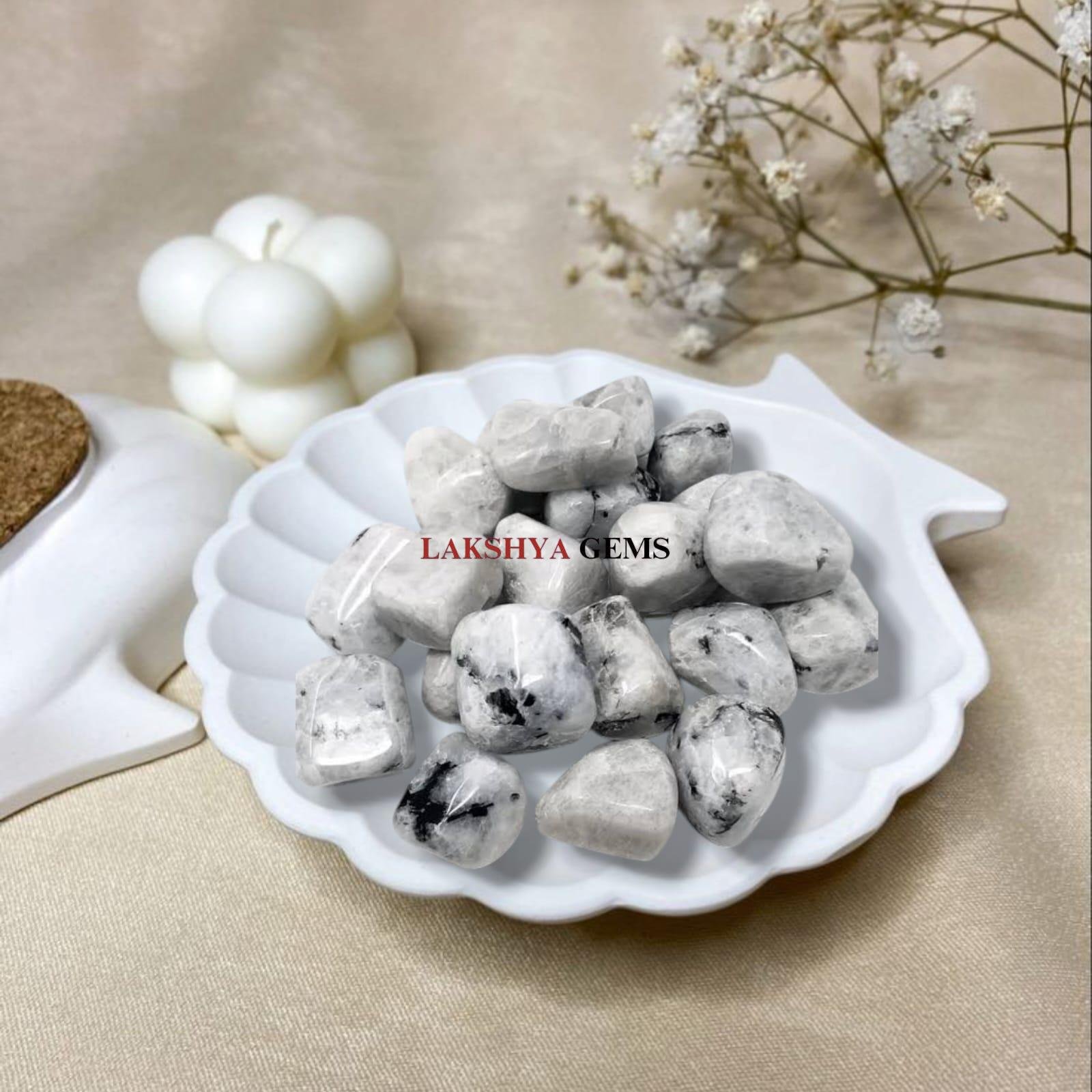 Polished Moonstone tumble stones with a soft milky white glow for intuition and calm.