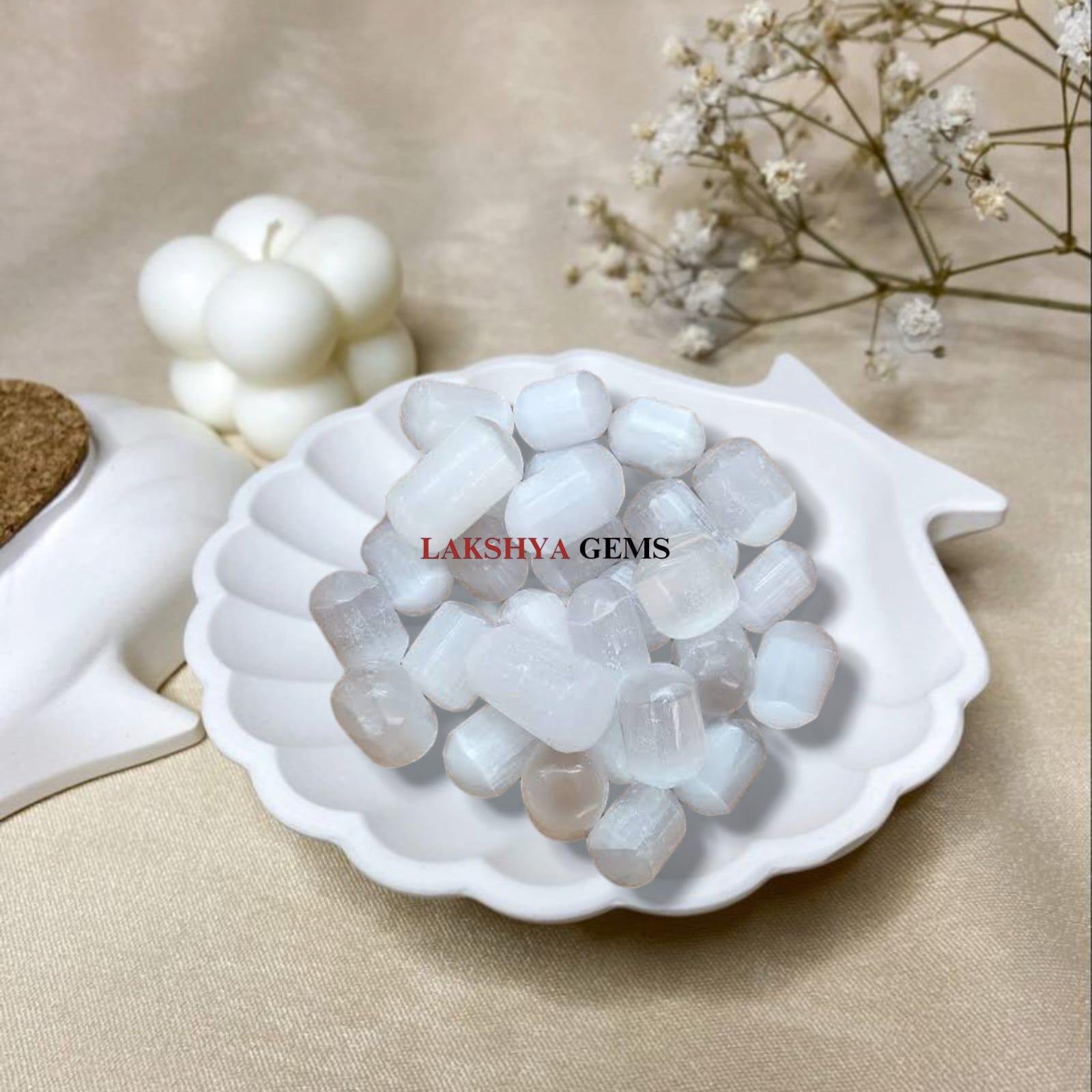 Polished Selenite tumble stones with a pearlescent white glow for energy clearing.
