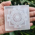 4-inch square round Selenite charging plate engraved with Shree Yantra for cleansing crystal jewelry.