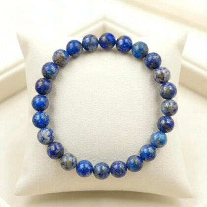 Natural Lapis Lazuli beaded bracelet featuring deep indigo blue stones with golden pyrite flecks.
