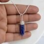 Natural Lapis Lazuli pencil pendant with deep blue color and golden pyrite inclusions.