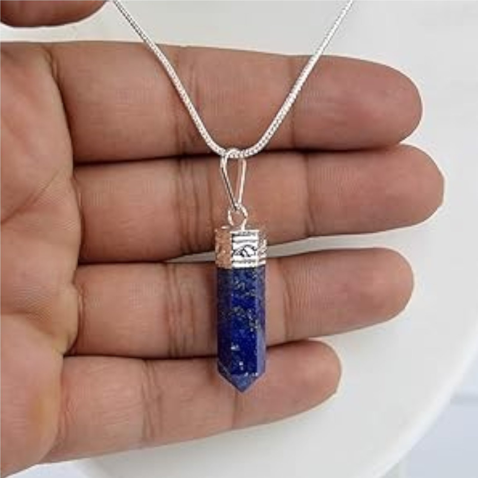 Natural Lapis Lazuli pencil pendant with deep blue color and golden pyrite inclusions.