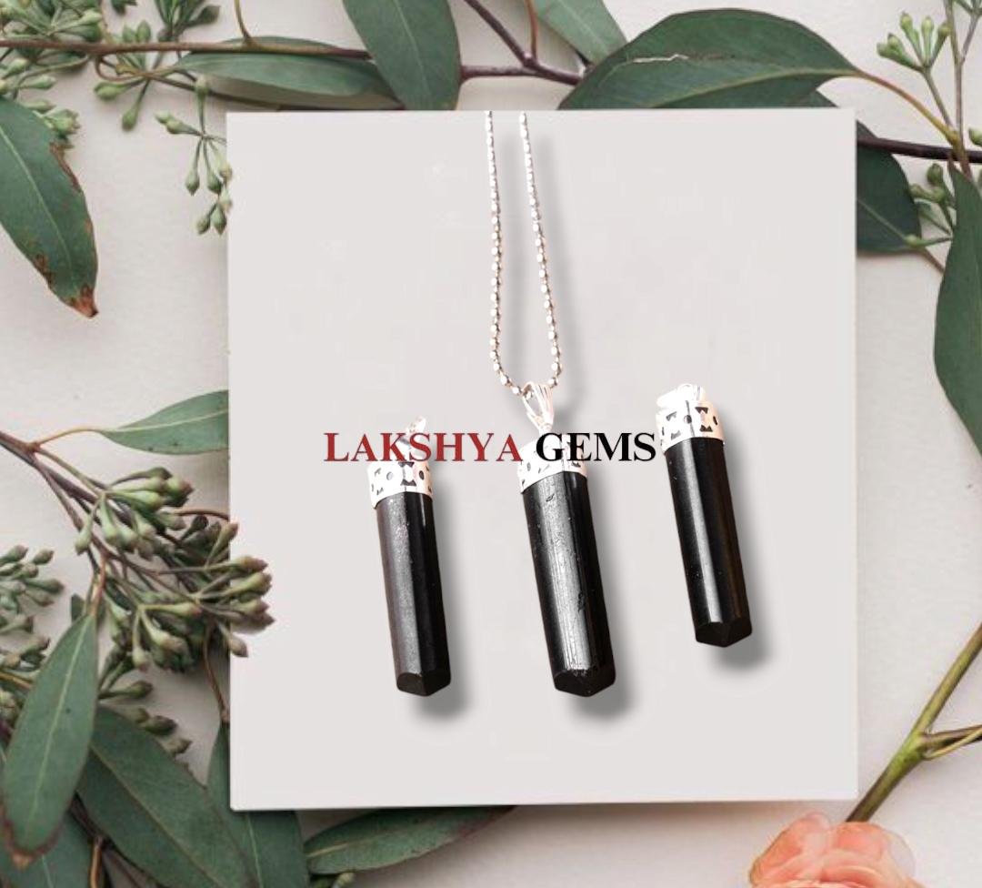 Natural Black Tourmaline pencil pendant with a deep jet-black luster and silver-toned bail.