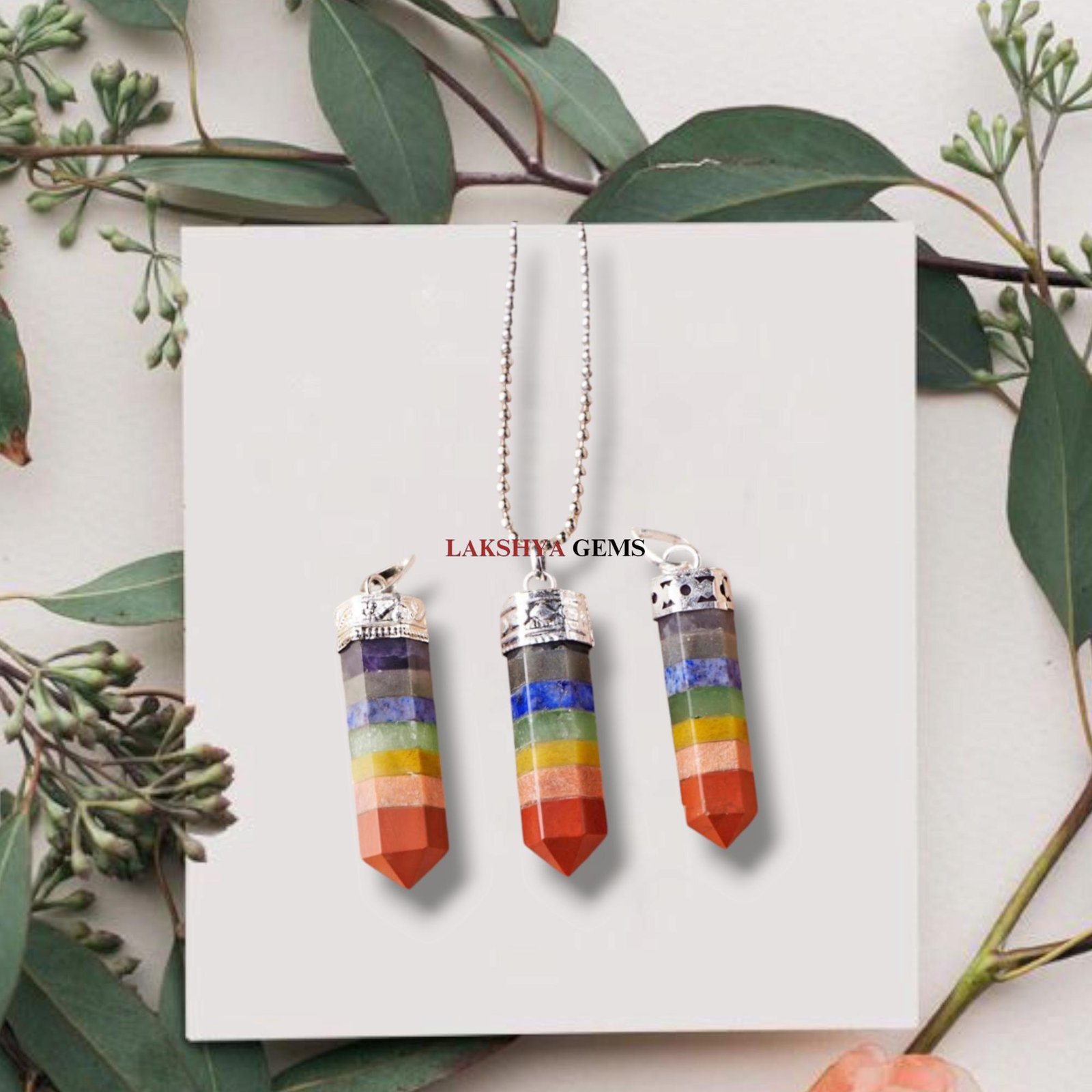 Natural Seven Chakra pencil pendant featuring seven layers of colorful healing gemstones.