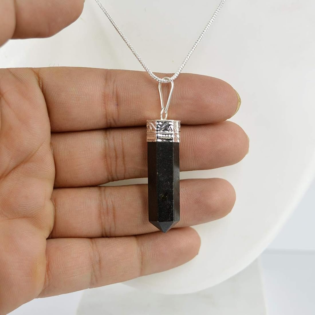 Natural Black Tourmaline pencil pendant with a deep jet-black luster and silver-toned bail.