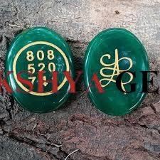 Natural Green Jade Zibu coin with engraved gold-toned prosperity symbol for wealth attraction.