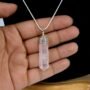 Natural Rose Quartz pencil pendant with soft pink translucent color and silver-toned bail. lakshya gems