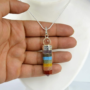 lakshya gems Natural Seven Chakra pencil pendant featuring seven layers of colorful healing gemstones.
