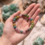 A natural Multi Tourmaline bracelet featuring a colorful mix of transparent pink, green, yellow, and black beads.