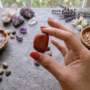 A collection of polished Red Jasper crystal tumbles showing a deep, opaque brick-red color and smooth surface.