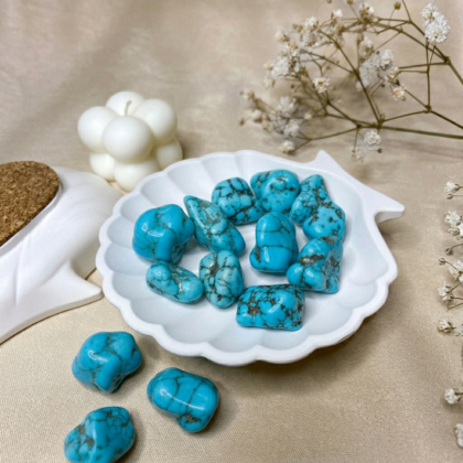 A collection of polished Turquoise crystal tumbles featuring vibrant sky-blue colors and natural dark matrix veining.
