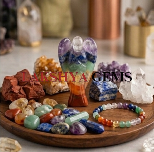 7 chakra crystal Angel from Lakshya Gems Mumbai A hand-bonded Seven Chakra crystal angel featuring layers of natural red, orange, yellow, green, blue, indigo, and violet gemstones.