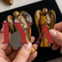 A hand-carved natural Tiger Eye crystal angel showing silky golden-brown bands and a polished finish.