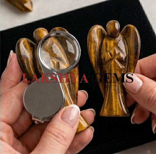 A hand-carved natural Tiger Eye crystal angel showing silky golden-brown bands and a polished finish.