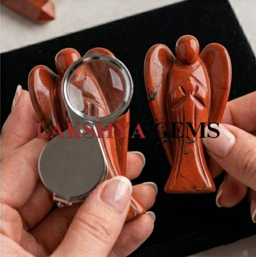 A hand-carved natural Red Jasper crystal angel featuring a deep terracotta red color and smooth polished finish.