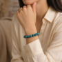 A natural Blue Apatite healing bracelet featuring round indigo-blue beads with a slight silky luster.