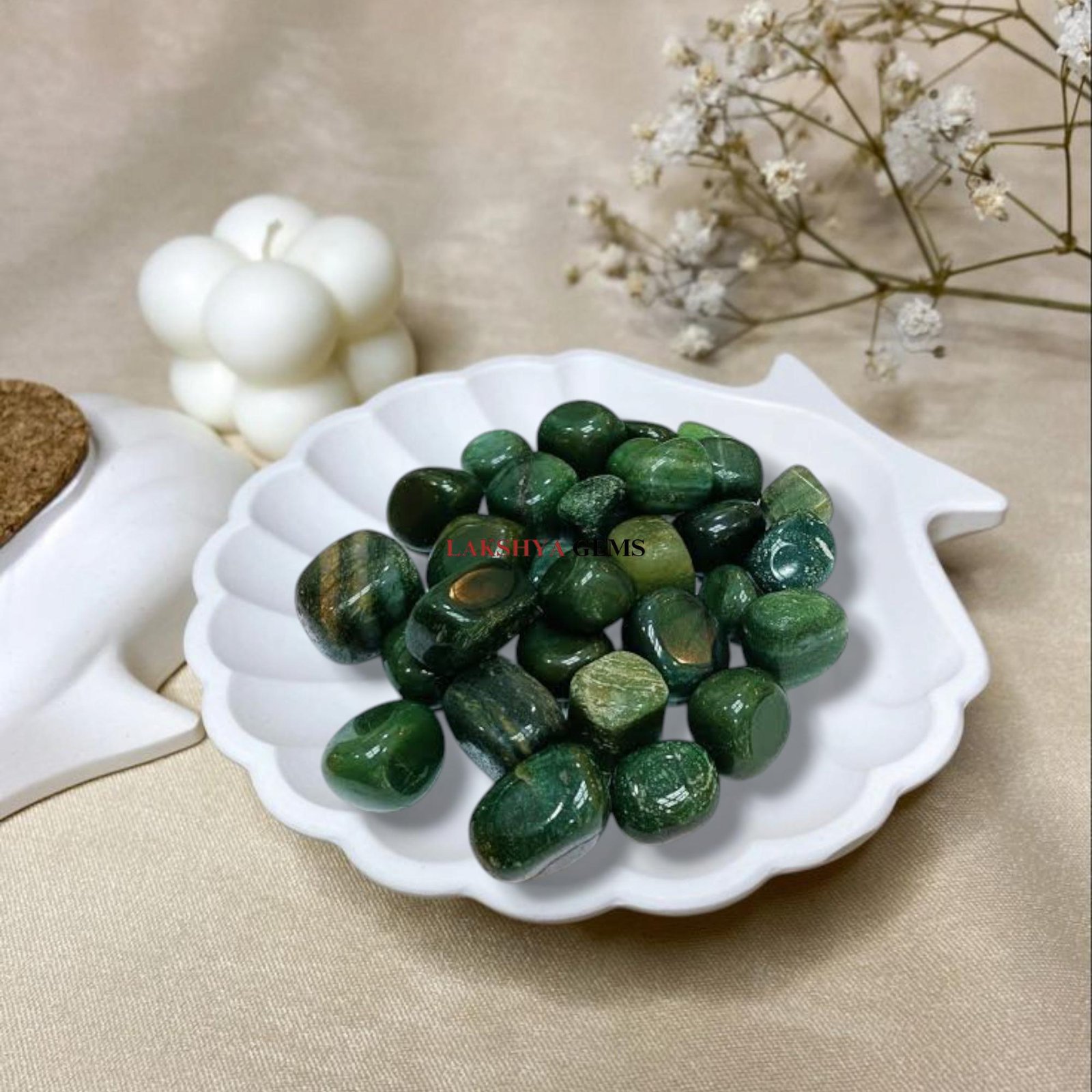 A collection of polished Green Jade crystal tumbles featuring various shades of vibrant forest and olive green.