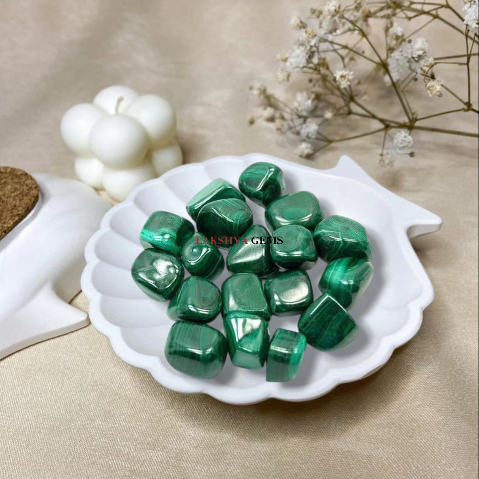 A collection of polished Malachite crystal tumbles featuring deep forest-green concentric bands and unique swirl patterns